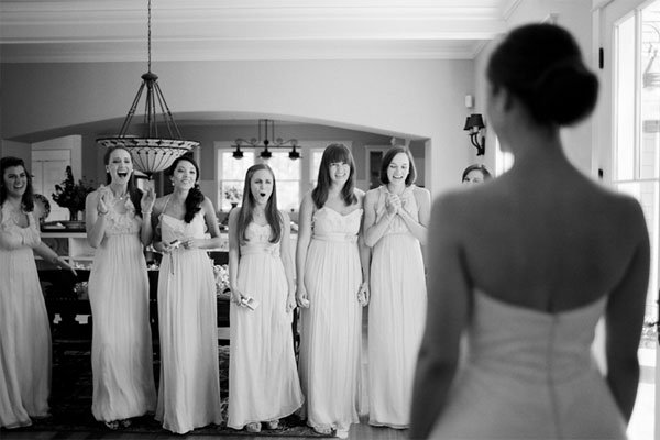 bridesmaids seeing the bride in her wedding gown for the first time