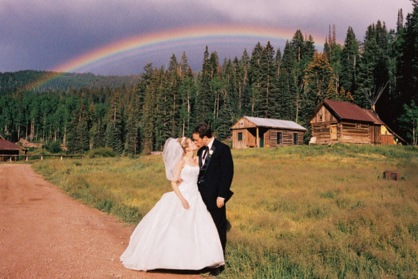 rainbow in background of wedding photo