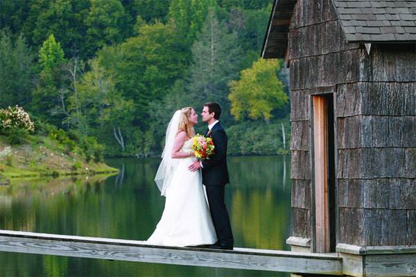 bride and groom on a lake