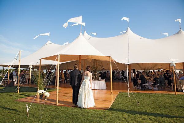 bride and groom in front of castle tent 