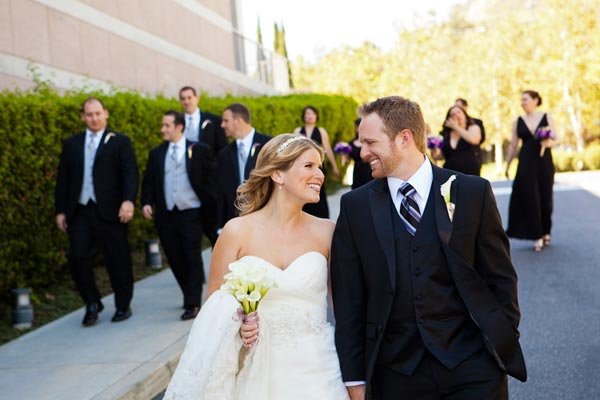 bride and groom with bridal party in the backround 