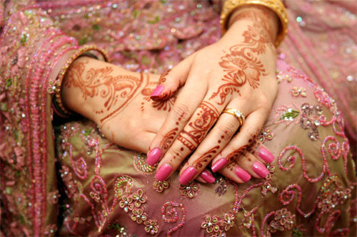 mehndi or henna is applied to the bride's hands and feet in pretty designs