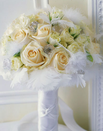 The bridal bouquet of satiny white roses glittering crystals and soft white