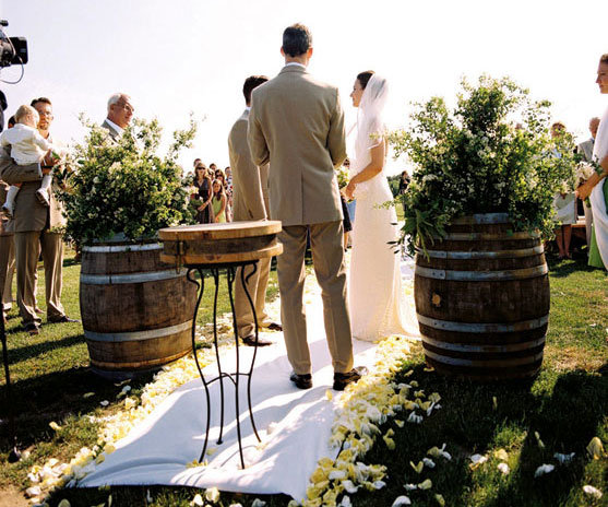 eco friendly wedding ideas A couple exchanges vows framed by barrels of 