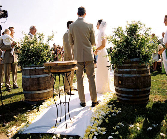 eco friendly wedding ideas A couple exchanges vows framed by barrels of