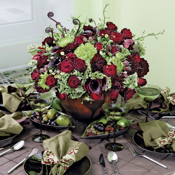 Types of Flowers A centerpiece of roses calla lilies and fiddlehead ferns