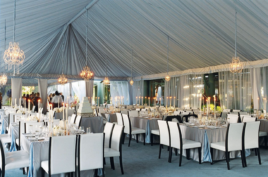 For a chic outdoor wedding in South Carolina a tent is lined with sheer 