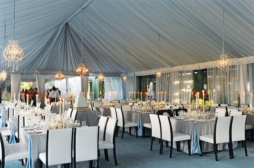 For a chic outdoor wedding in South Carolina a tent is lined with sheer