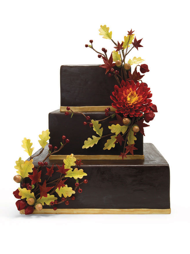 Chocolate fondantcovered wedding cake with sugarpaste red dahlia oak and 