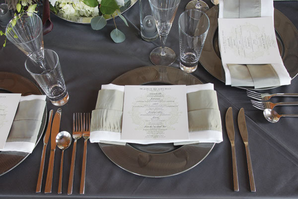 Oversize chargers in brushed gunmetal gave each place setting extra shine