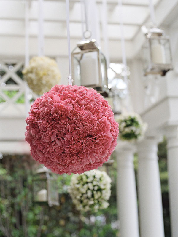 Pale pink and white peonies and gardenias adorned the wroughtiron gates 