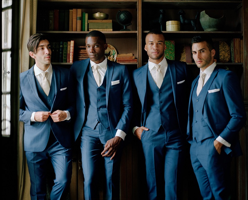 groom and groomsmen in library for Generation Tux