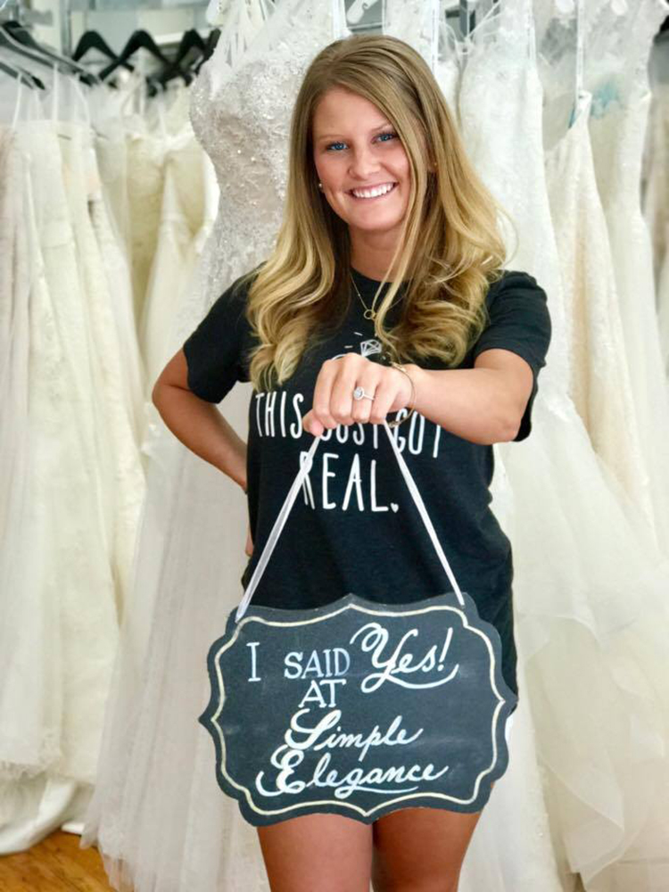 Bride at Simple Elegance bridal shop with SAID YES sign