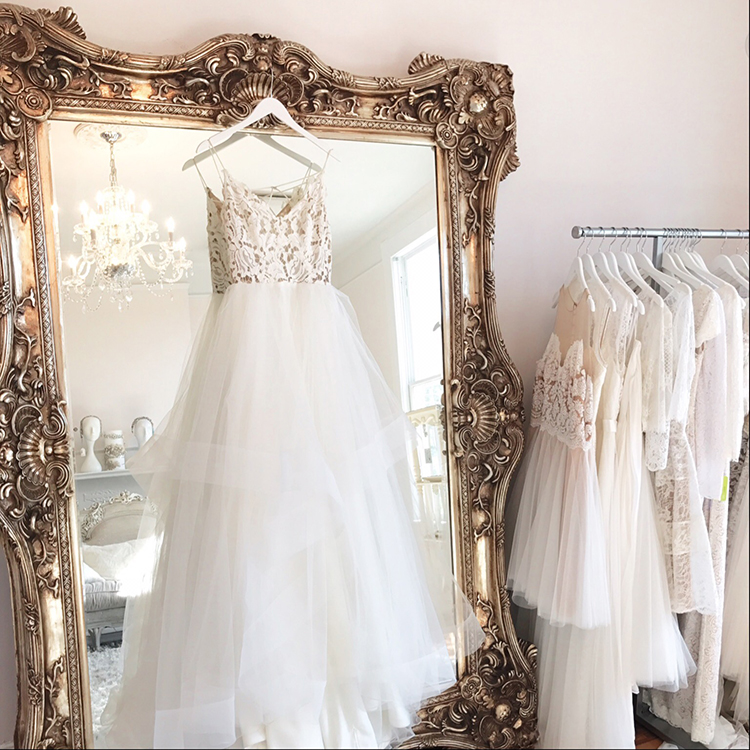 hanging wedding dresses at bridal salon