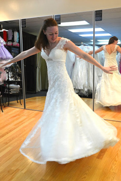 bride trying on new wedding gown
