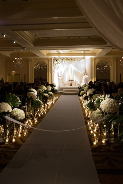 candles and flowers at indoor ceremony