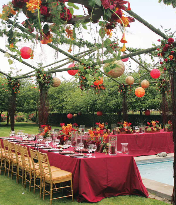 Pillar candles in merlot tones are set off by tables draped in 