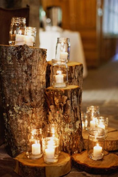 mason jar candles on tree stumps