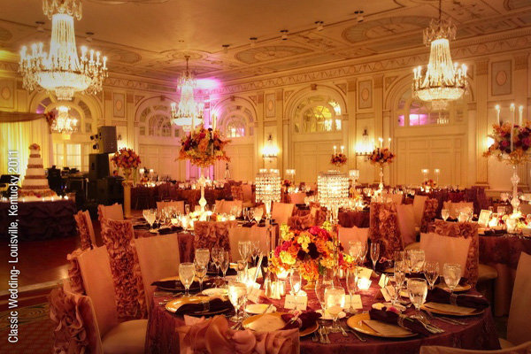 Rosecovered chairs enhance the glamour of this ballroom wedding reception