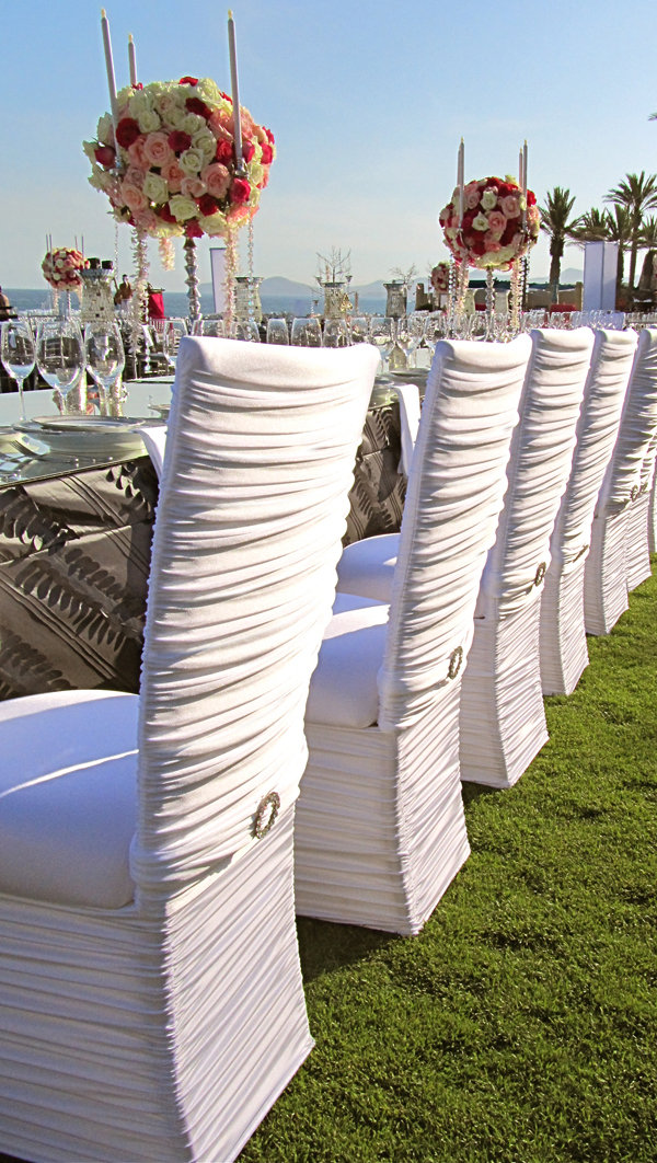 White chair covers work equally well at an outdoor wedding