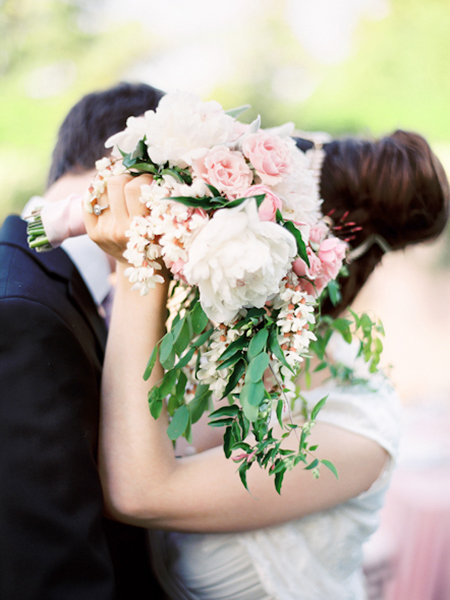 newlyweds holding bouquet