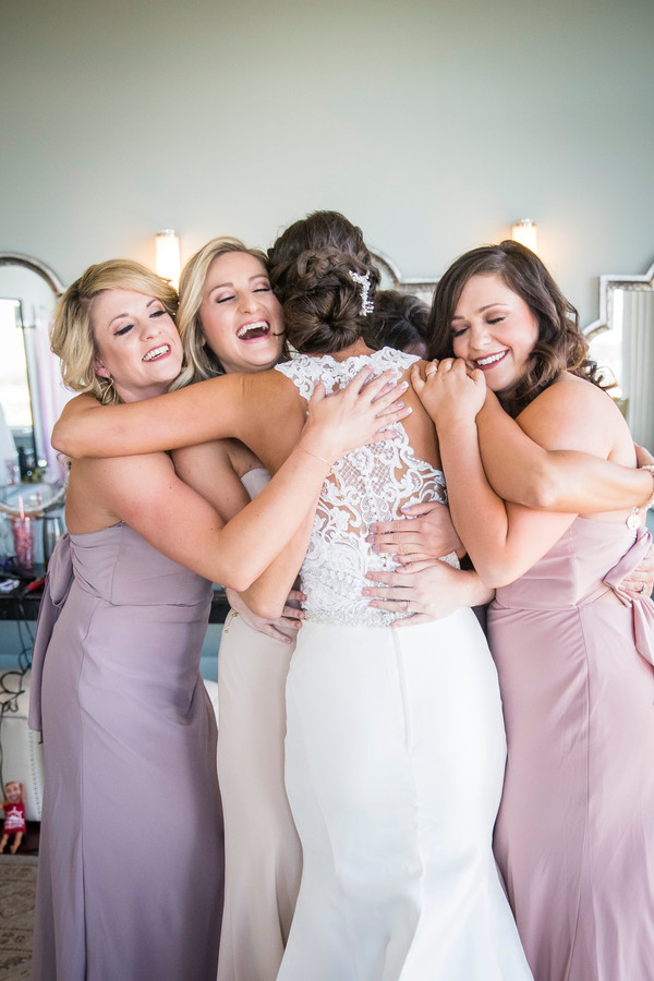 Group hug bride and bridesmaids