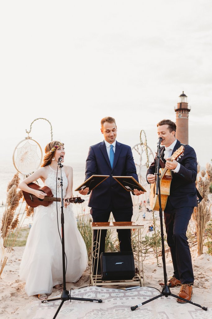 Bride and groom playing guitar at wedding ceremony