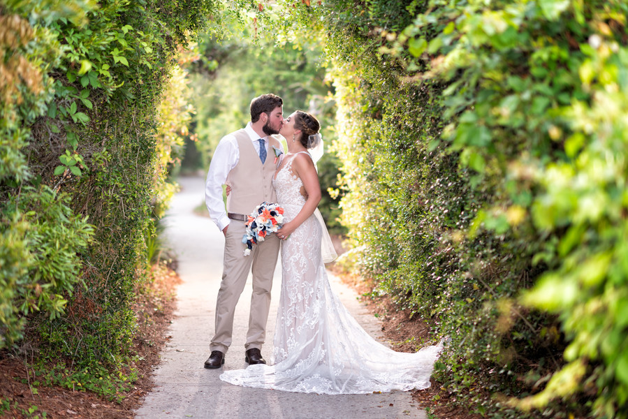 Bride and groom kissing in the garden