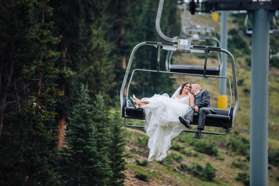 Bride and groom wedding photo on ski lift
