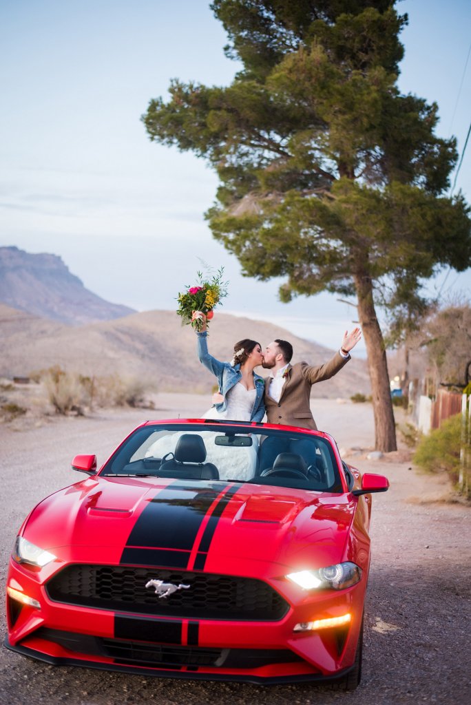 Bride and groom in convertible car