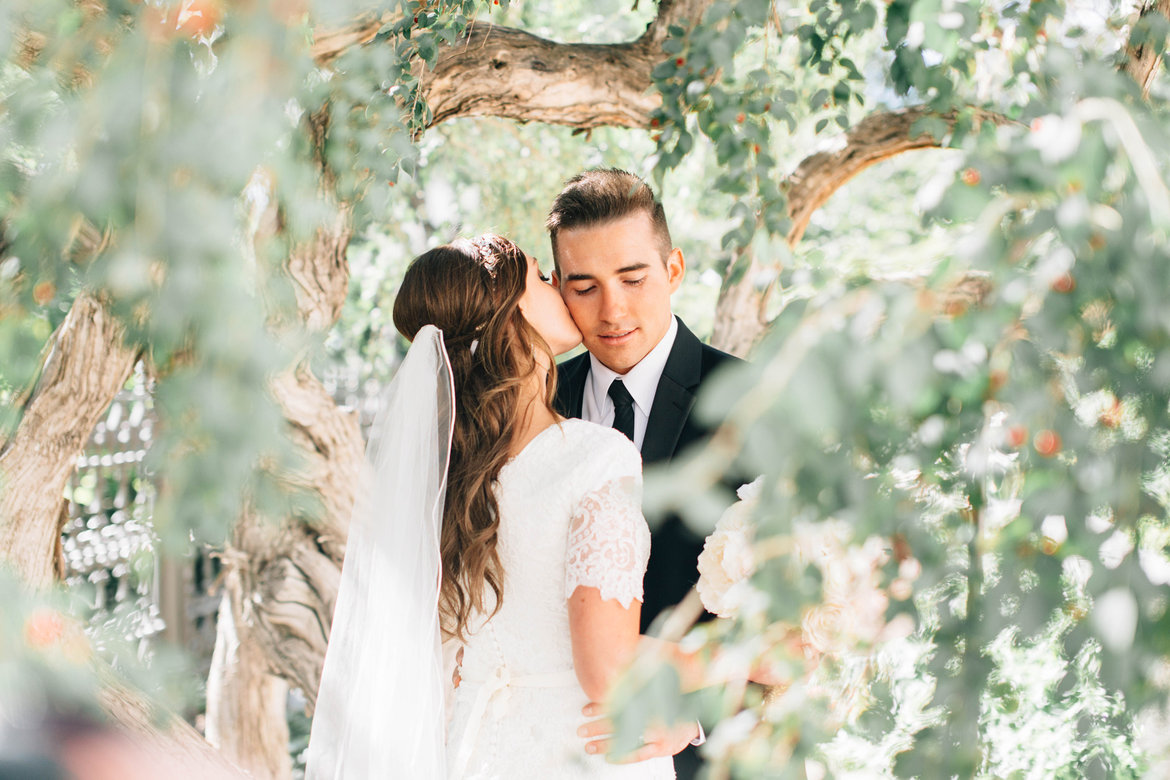 bride and groom through the trees