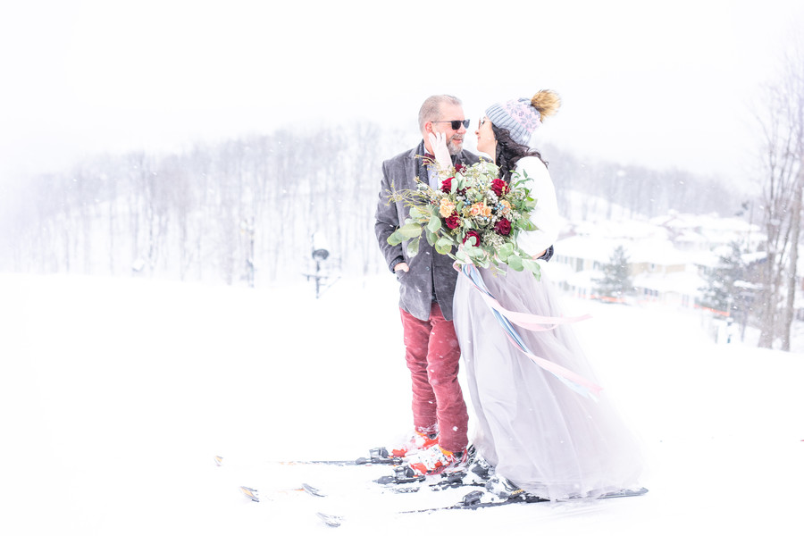 winter wedding bride and groom on skis