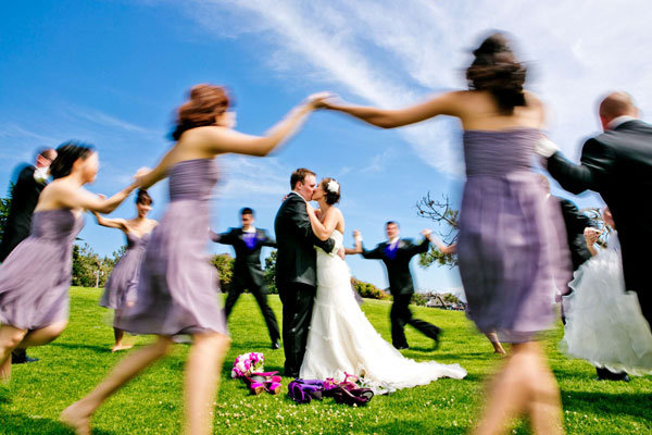 bridal party circling the couple