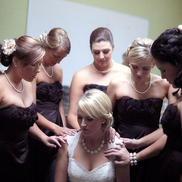 bride and bridesmaids praying