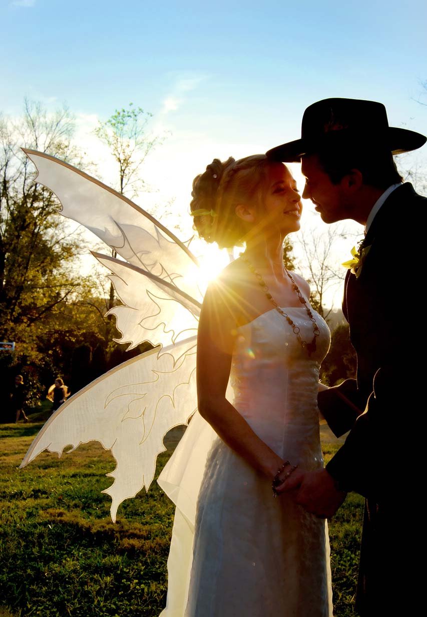 bride wearing fairy wings halloween theme wedding