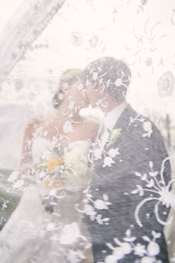 bride and groom through the veil