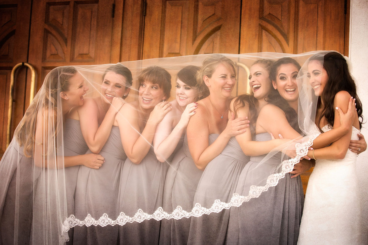 bridesmaids under brides veil