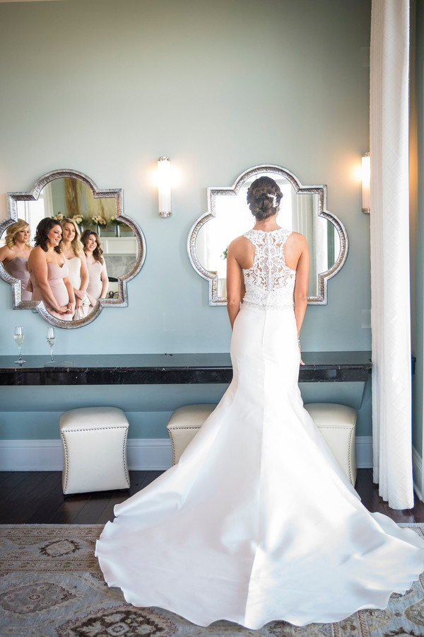 Bride with bridesmaids in the mirror