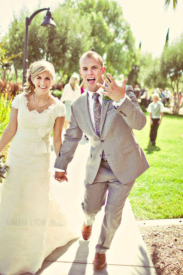 excited groom showing off wedding ring