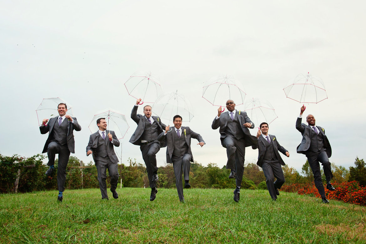 groomsmen frolicking in the rain