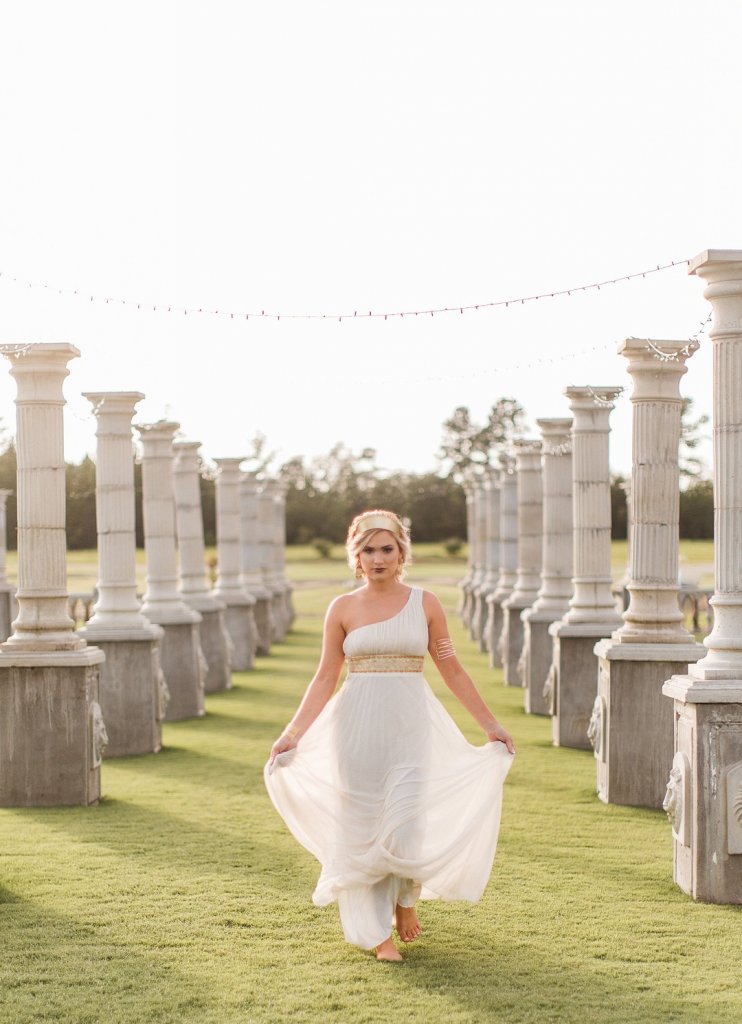 Bride waking through Greek columns