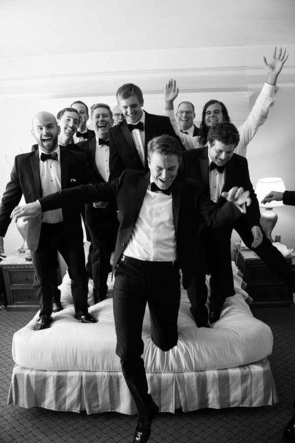 groomsmen jumping on bed