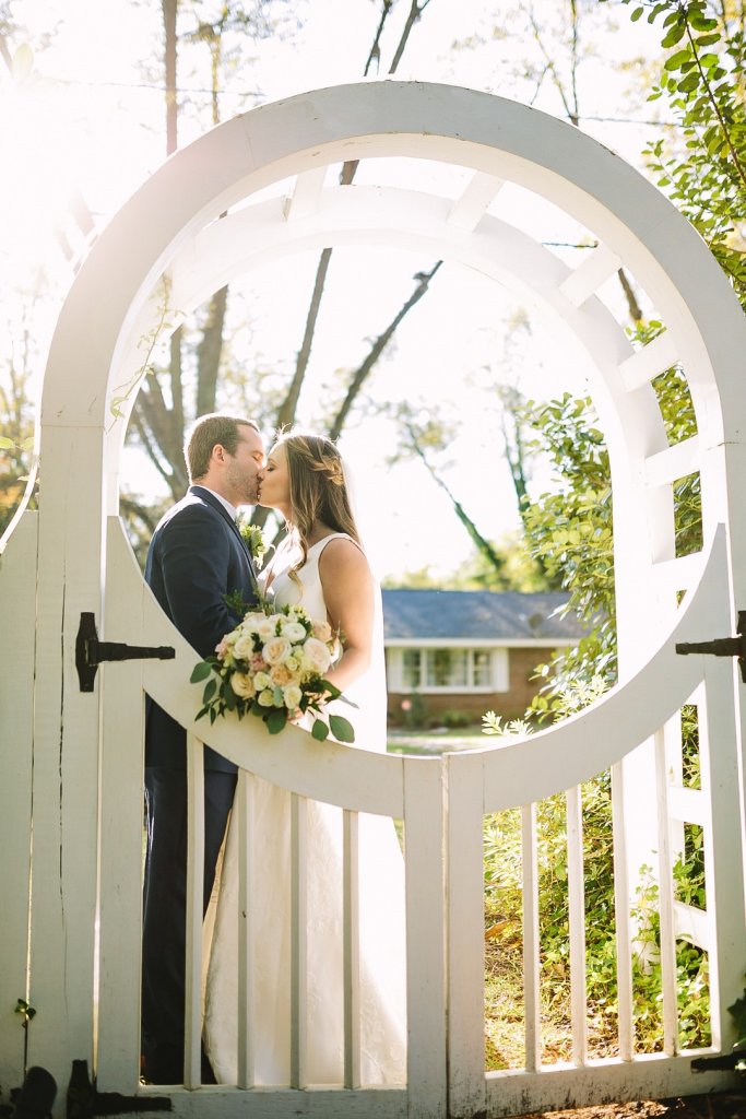 Bride and groom framed by a gate