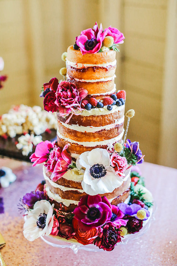 naked cake with vibrant flowers