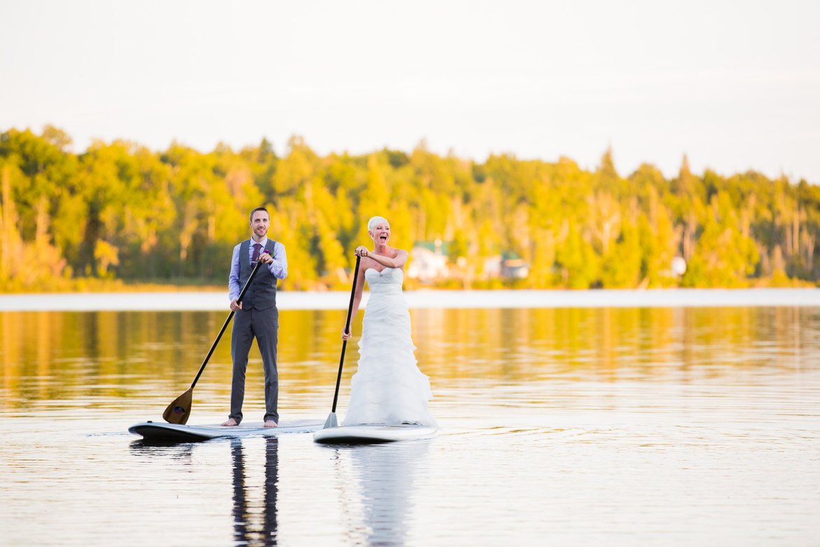 paddleboarding bride and groom