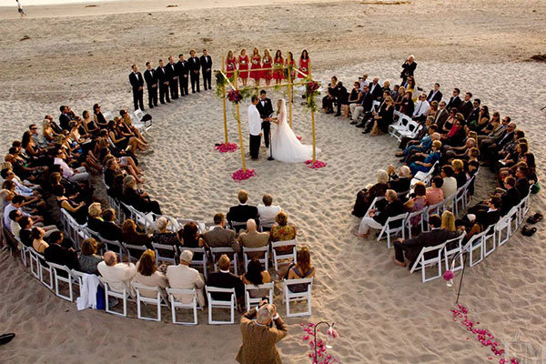 surrounded by guests at wedding ceremony