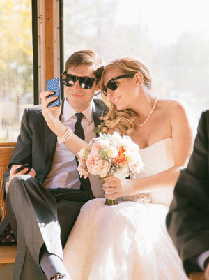bride and groom taking selfie 