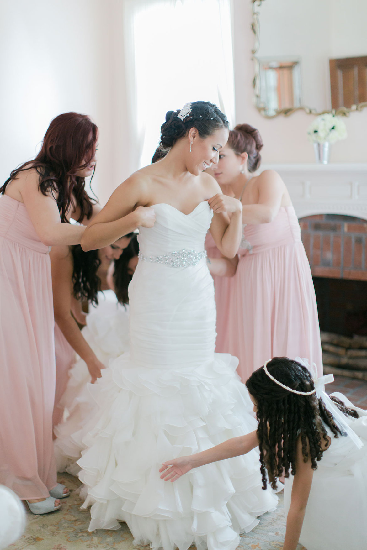 bride trying on wedding dress