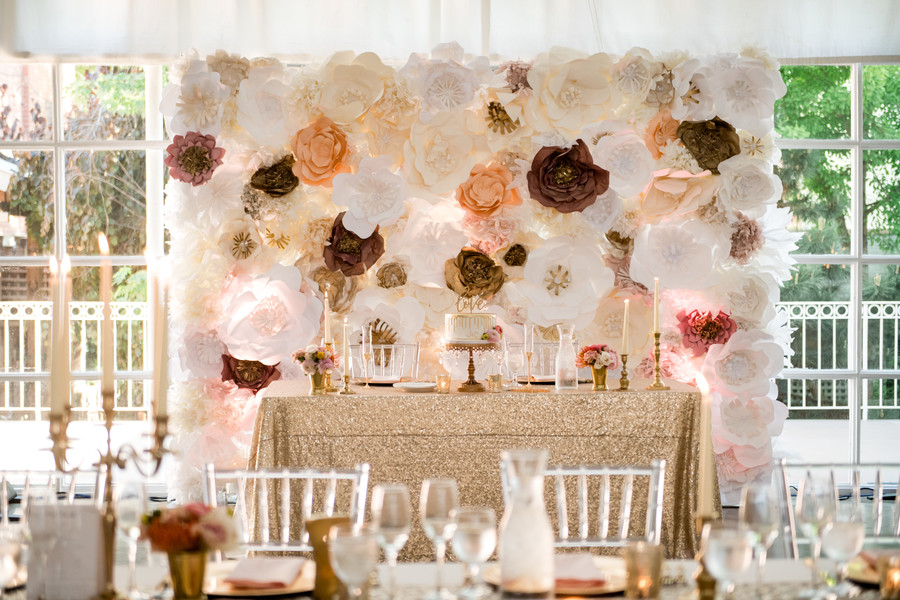floral wall behind dessert table at wedding