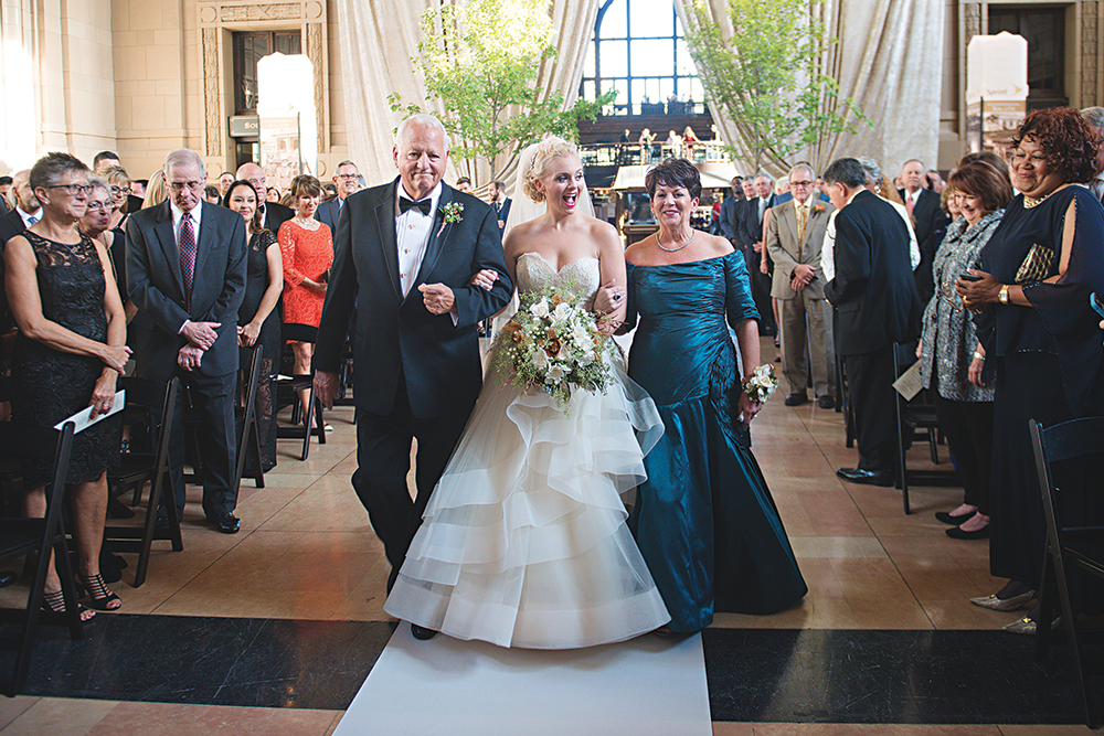 bride and parents walking down aisle